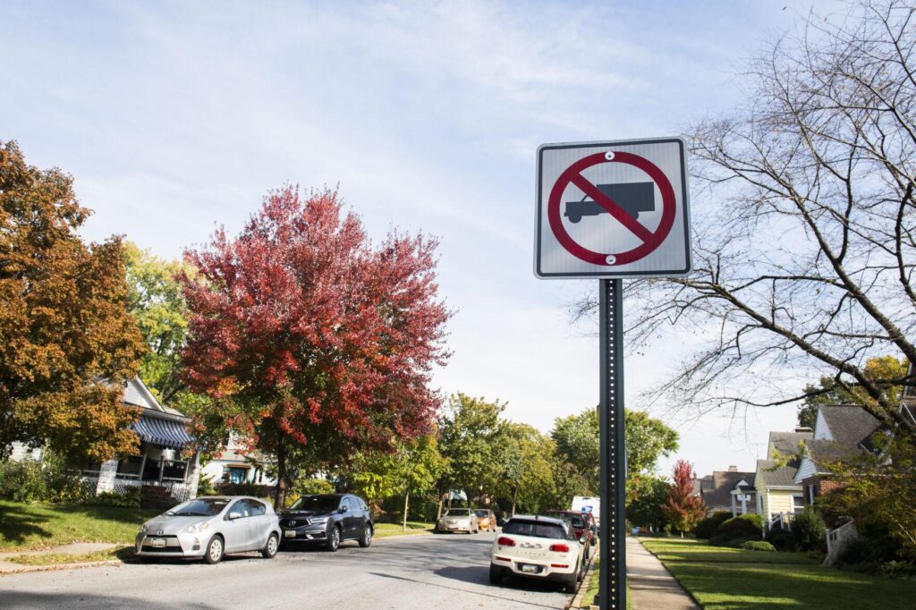 What prompts the need for a no parking sign in front of homes
